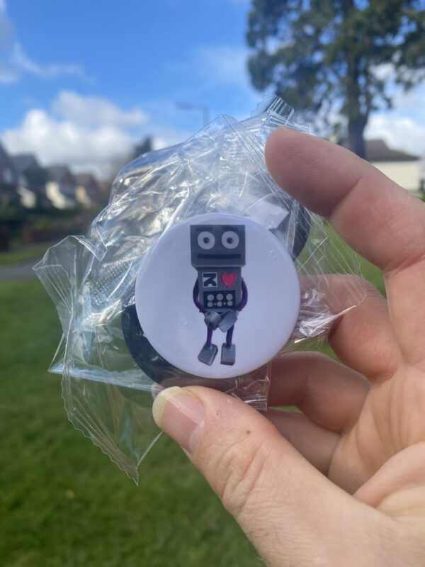 a robot pin badge